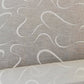 Glass curtain embroidered with waves in white, grey, beige and blue