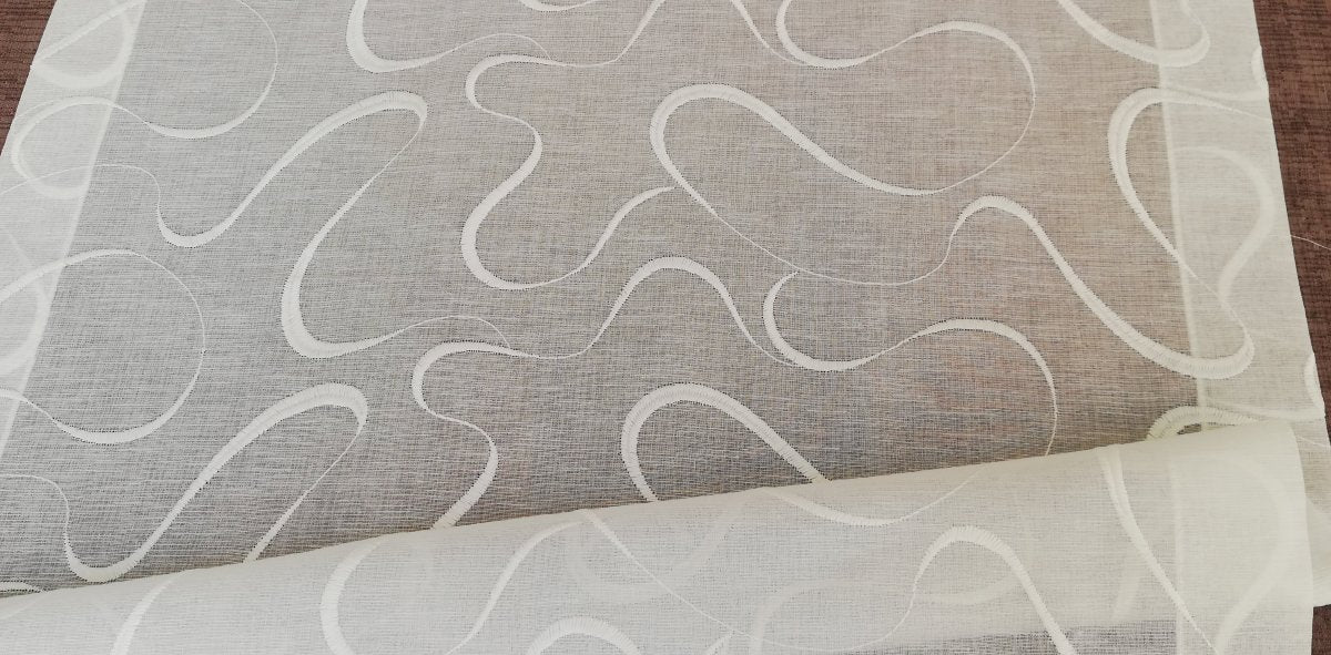 Glass curtain embroidered with waves in white, grey, beige and blue