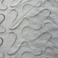 Glass curtain embroidered with waves in white, grey, beige and blue